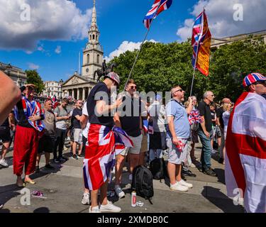 London, UK. 27th July, 2024. Thousands of supporters of Tommy Robinson, real name Stephen Yaxley-Lennon, have marched from the Royal Courts of Justice and are now gathered for a rally in Trafalgar Square, central London. Many have brought Union Jack and St George's Cross flags or are wearing Union Jack colours. Credit: Imageplotter/Alamy Live News Stock Photo