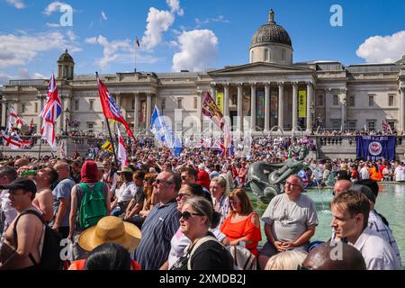 London, UK. 27th July, 2024. Thousands of supporters of Tommy Robinson, real name Stephen Yaxley-Lennon, have marched from the Royal Courts of Justice and are now gathered for a rally in Trafalgar Square, central London. Many have brought Union Jack and St George's Cross flags or are wearing Union Jack colours. Credit: Imageplotter/Alamy Live News Stock Photo