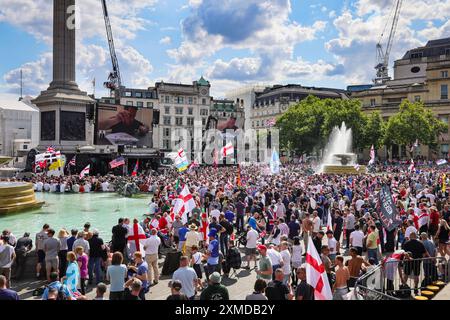 London, UK. 27th July, 2024. Supporters watch a video of Mr. Yaxley. Thousands of supporters of Tommy Robinson, real name Stephen Yaxley-Lennon, have marched from the Royal Courts of Justice and are now gathered for a rally in Trafalgar Square, central London. Many have brought Union Jack and St George's Cross flags or are wearing Union Jack colours. Credit: Imageplotter/Alamy Live News Stock Photo