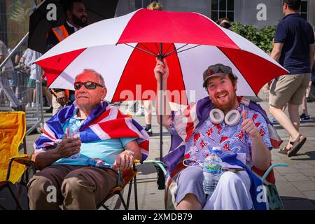 London, UK. 27th July, 2024. Thousands of supporters of Tommy Robinson, real name Stephen Yaxley-Lennon, have marched from the Royal Courts of Justice and are now gathered for a rally in Trafalgar Square, central London. Many have brought Union Jack and St George's Cross flags or are wearing Union Jack colours. Credit: Imageplotter/Alamy Live News Stock Photo