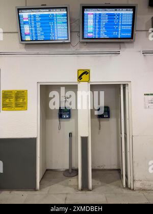 Payphones, cabins, in the departure hall of Heraklion airport on the Greek island of Crete, monitors with departure information Stock Photo