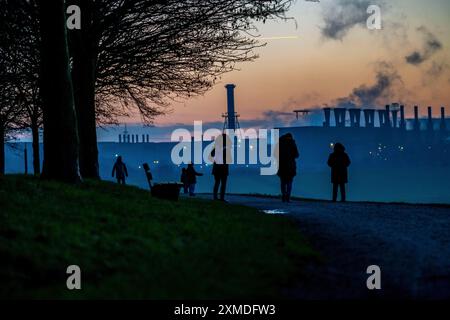 Rhine at Duisburg-Bruckhausen, steelworks Thyssenkrupp Steel, walkers on the Rhine dyke, winter, Duisburg, North Rhine-Westphalia, Germany Stock Photo