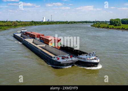 Cargo ship Mellizo, container freighter, only partly loaded, on the Rhine near Duisburg-Baerl, in the background the STEAG power plant Walsum North Stock Photo