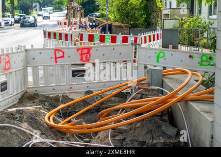 Laying of fibre optic cables, empty conduits are laid under a pavement, in which the actual fibre optic cable is later blown in and connected to the Stock Photo