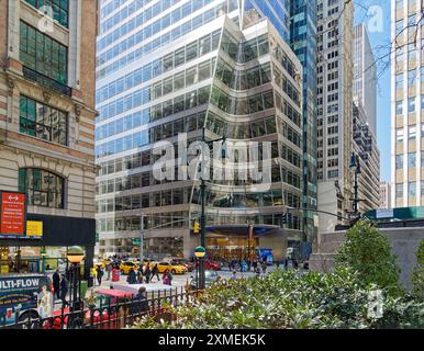 A cone is sculpted from the corner of 7 Bryant Park above the circular canopy, at the corner of West 40th Street and Avenue of the Americas. Stock Photo