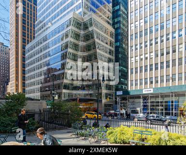 A cone is sculpted from the corner of 7 Bryant Park above the circular canopy, at the corner of West 40th Street and Avenue of the Americas. Stock Photo