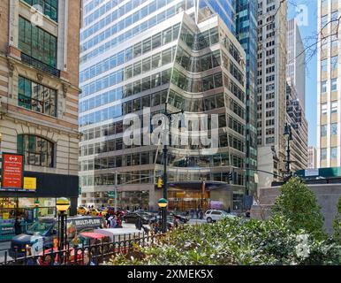 A cone is sculpted from the corner of 7 Bryant Park above the circular canopy, at the corner of West 40th Street and Avenue of the Americas. Stock Photo