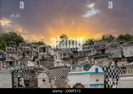 Cemetery, Mausoleums Or Large Crypts Decorated With Tiles, Often In Black And White. Densely Built Buildings Under A Sunset Cimetière De Morne-à-l'eau Stock Photo