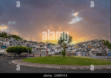 Cemetery, Mausoleums Or Large Crypts Decorated With Tiles, Often In Black And White. Densely Built Buildings Under A Sunset Cimetière De Morne-à-l'eau Stock Photo