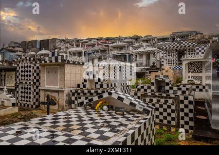 Cemetery, Mausoleums Or Large Crypts Decorated With Tiles, Often In Black And White. Densely Built Buildings Under A Sunset Cimetière De Morne-à-l'eau Stock Photo