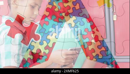 Jigsaw puzzle and ribbon icon against two diverse boys using smartphone at school. Autism and school education concept Stock Photo
