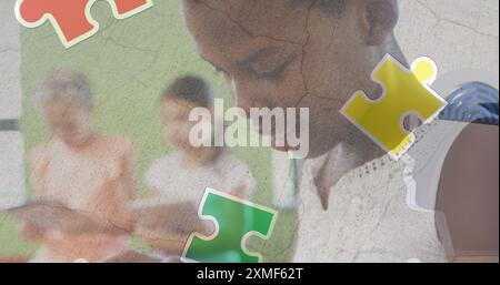 Jigsaw puzzle and human head icon over african american girl using digital tablet at school. Autism and school education concept Stock Photo
