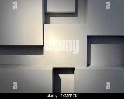 Square wall panels cast shadows under hard light. Stock Photo