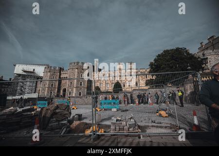 Windor Castle, UK - October 16, 2023 : A view of Windsor Castle from behind a metal fence with construction happening in front of the castle. Stock Photo