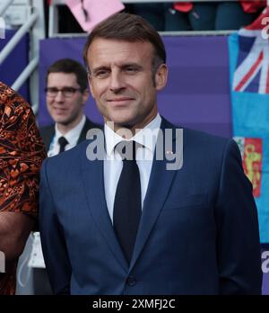 France's President Emmanuel Macron smiles and gestures at Elysee Palace ...