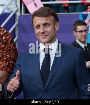 France's President Emmanuel Macron smiles and gestures at Elysee Palace ...