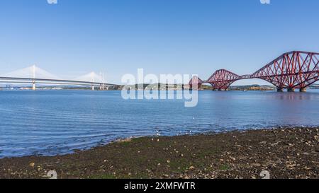 Bridges over the Firth of Forth, with the Queensferry Crossing and the Forth Road Bridge on the left and the Forth Bridge on the right, seen from Sout Stock Photo