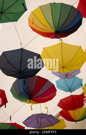 Colourful umbrellas hanging in a marquee roof Stock Photo