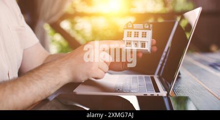 Businessman analyzing investment charts with calculator and laptop. Double exposure. Stock Photo