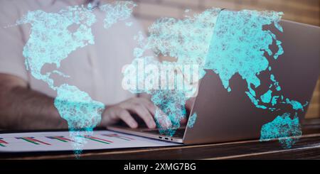 A businessman is using a laptop with a world map on the screen. A businessman uses a global business network server to trade Stock Photo