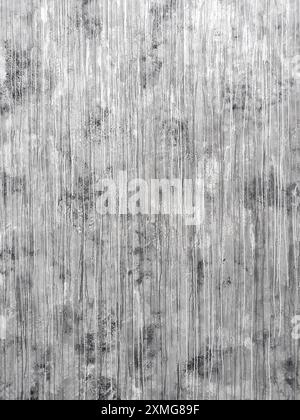 Gray textured wall with white vertical paint streaks, creating an abstract, weathered look. Artistic and industrial style perfect for modern interiors Stock Photo