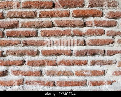 The background of the wall is made of old red brickwork in full screen Stock Photo