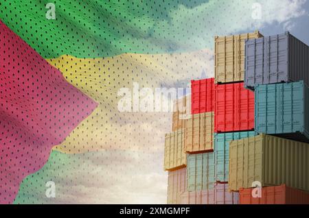 Sao Tome and Principe flag and big stack of shipping cargo containers in docks with sky background close up Stock Photo