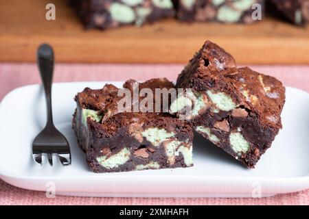 Two mint aero chocolate brownies served on a plate. The brownies are homemade and still warm and gooey from the oven Stock Photo