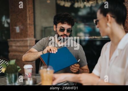 Business partners discussing new project over coffee in a modern coffee shop Stock Photo