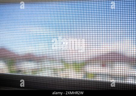 damaged mosquito net wire screen on house window protection against insect Stock Photo