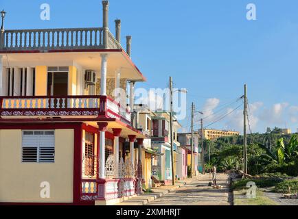 551 Eclectic and Colonial townhouses under the afternoon sun on the SW facing Calle Calixto Garcia Street, waterfront of the inner bay. Baracoa-Cuba. Stock Photo