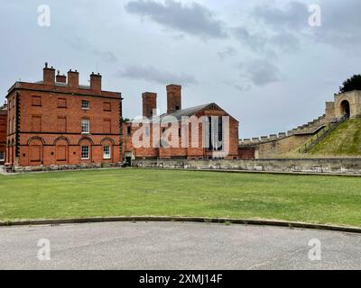 View from the inside of the castle walls, of the Museum of Lincolnshire Life, the Victorian Prison, and the Lucy Tower section of the castle wall. Stock Photo