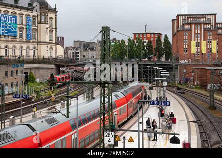 Passengers on platform with Hanse-Express train at rail 7 of Central Station in Hamburg, Germany Stock Photo