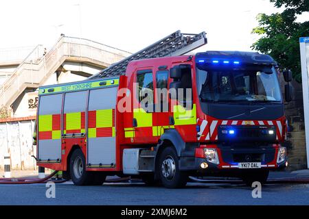 A Volvo fire engine pump in use by West Yorkshire Fire & Rescue at a building fire in Leeds. Stock Photo