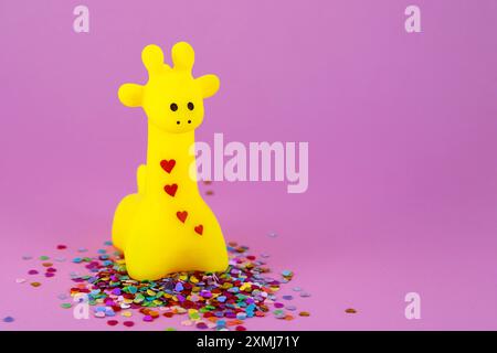 Cute yellow giraffe surrounded by hearts Stock Photo