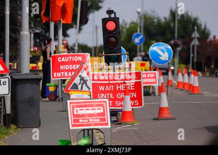 Roadworks signs and temporary traffic lights Stock Photo - Alamy