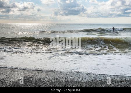 Surfer on the Beach in Levanto Village, Cinque Terre, Italy Stock Photo