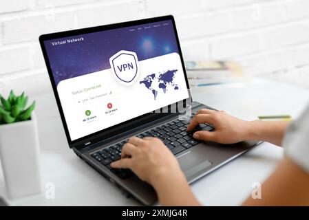 Using a VPN on a laptop. Web page concept with VPN connection and world map, emphasizing global online security and privacy Stock Photo