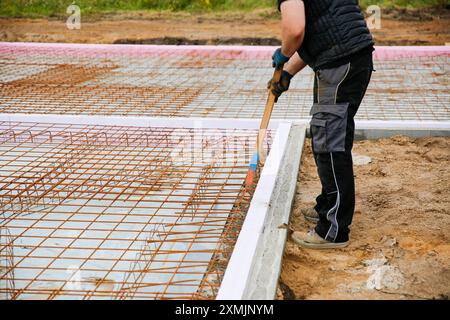 A male construction worker standing on a construction site. Family house build concept  Stock Photo