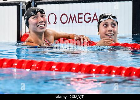 Paris, France. 28th July, 2024. Torri Huske of United States of America, gold, and Gretchen Walsh of United States of America, silver react after the swimming 100m Butterfly Women Final during the Paris 2024 Olympic Games at La Defense Arena in Paris (France), July 28, 2024. Credit: Insidefoto di andrea staccioli/Alamy Live News Stock Photo