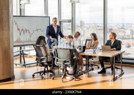 Business Professionals Discussing Financial Data in a Modern Office Stock Photo