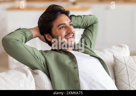 Relaxed Man Leaning Back on a Couch at Home Stock Photo