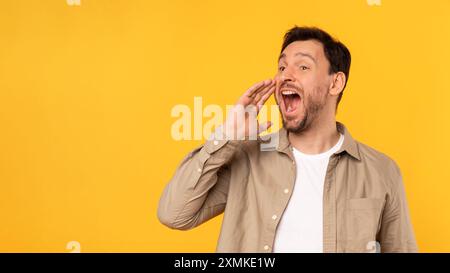 Man Shouting Loudly at a Yellow Wall Stock Photo
