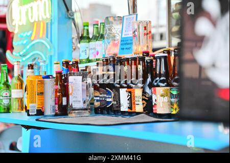 Taiwan - Jul 28, 2024: Tourists enjoy a picturesque sunset while dining at Dadaocheng Pier Plaza, a vibrant riverside spot in Taipei. Stock Photo