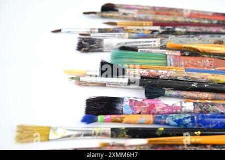 Paint brushes well used and covered in paint – Wales, UK  – 19 July 2024 Stock Photo