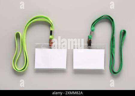 Blank badges with lanyards on grey background Stock Photo