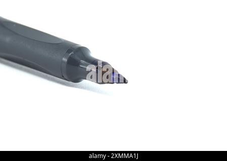Detailed close-up of black permanent marker with white background. Ideal for office supplies, school projects, and art use. Stock Photo