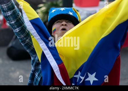 Santiago, Chile. 28th July, 2024. A woman harangues amid waiting for the results of the Venezuelan presidential election in Santiago, Chile, on July 28, 2024. Thousands of Venezuelans arrived at the Venezuelan embassy in Santiago, Chile to participate in the elections from abroad. (Photo by Jesus Martinez/Sipa USA) Credit: Sipa USA/Alamy Live News Stock Photo