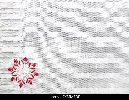 Horizontal Christmas background with wool sweater texture and felt snowflake. Background for scrapbooking design, decoration with knitted wool materia Stock Photo