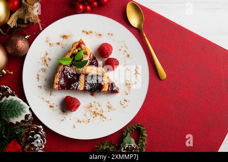 Delicious Italian crostata filled with red fruit jam on a christmas table for holidays. Stock Photo